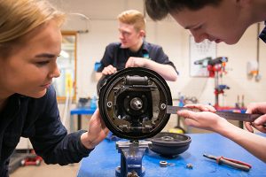engineering students measuring something in the workshop