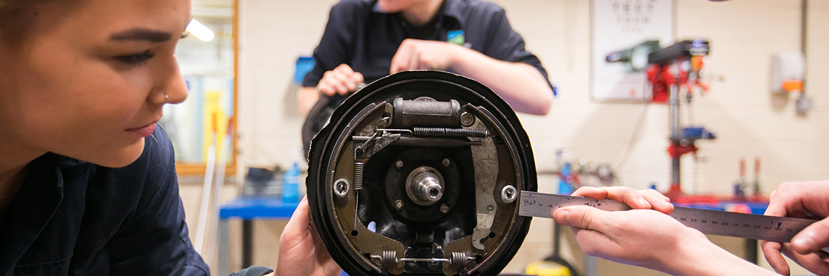engineering students measuring something in the workshop