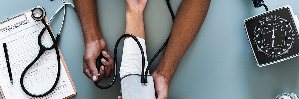 a person taking someones blood pressure