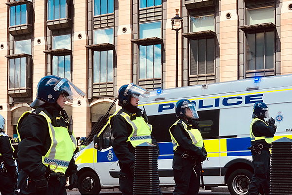 police standing in a row in riot gear