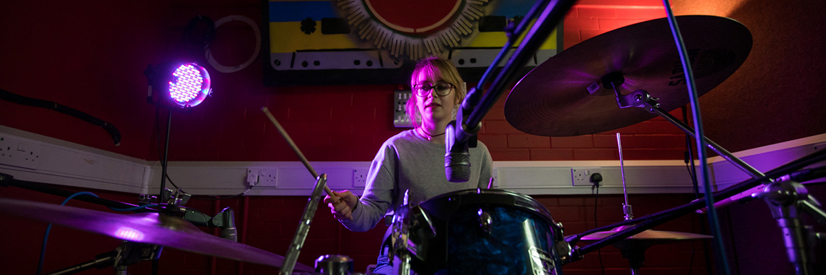 a female student playing drums