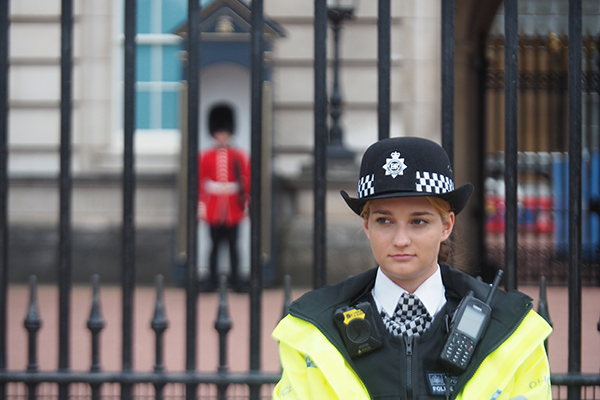 policewoman standing in front of Buckingham palace
