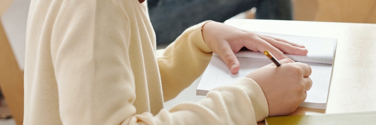child working at a desk in class