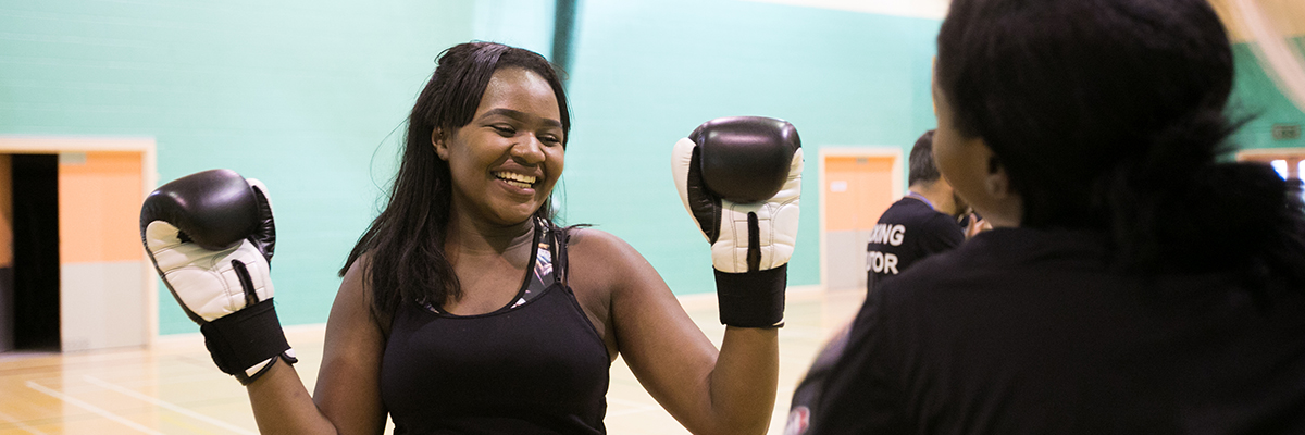 student with boxing gloves on