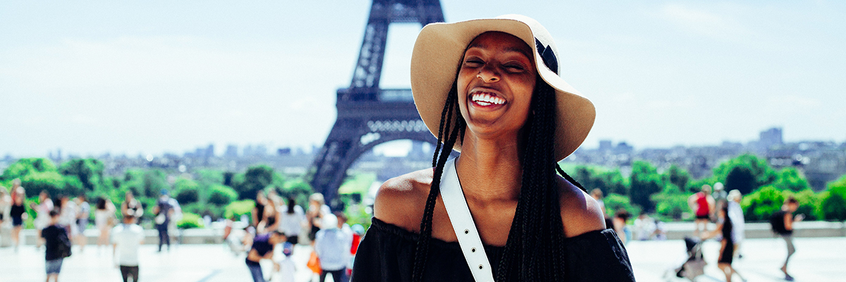 a woman standing in front of the Eiffel tower