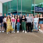 large group of students in front of Alton campus reception with staff members