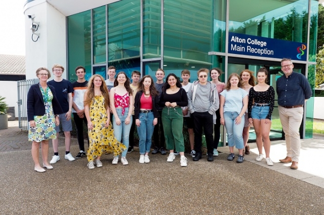 large group of students in front of Alton campus reception with staff members