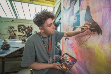 a student working on a painting