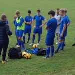 football team in Chelsea kit having team talk