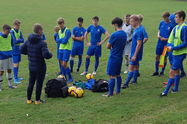 football team in Chelsea kit having team talk