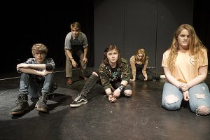 drama students posing on stage