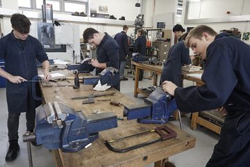 student working at benches in engineering workshop