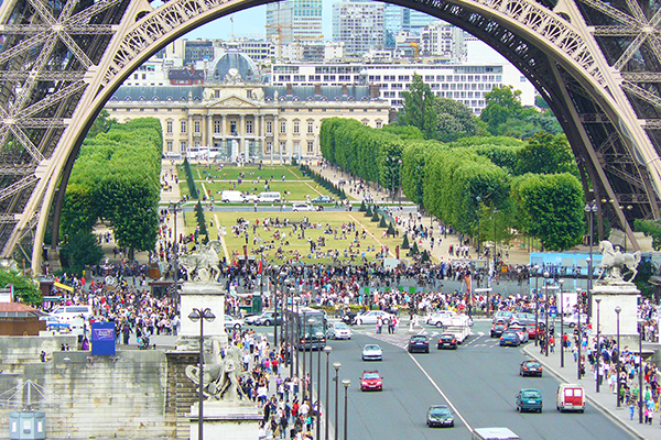 the bottom of the eiffel tower with traffic flowing underneath