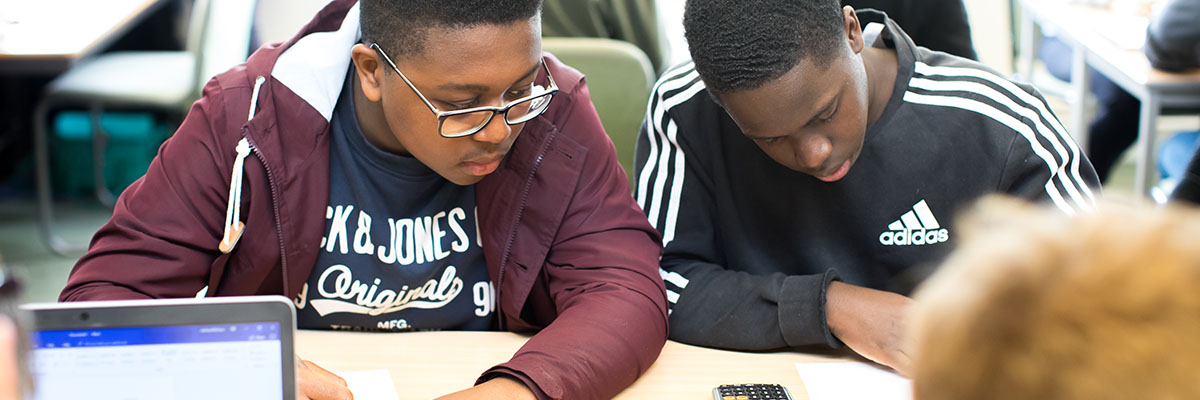 two students working together at a desk