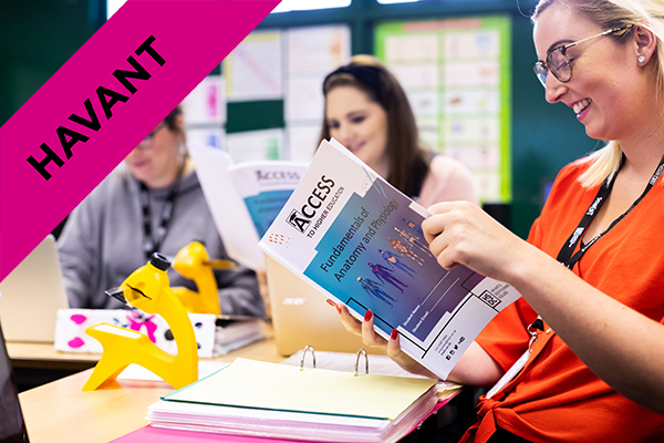 HSDC students in an Access to HE Nursing and Healthcare class holding a work book