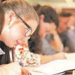 students writing on paper