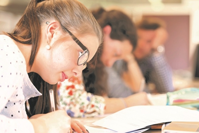 students writing on paper