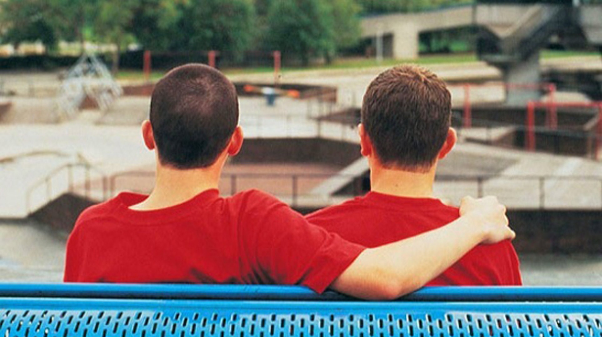 two students on a bench with their back to the camera
