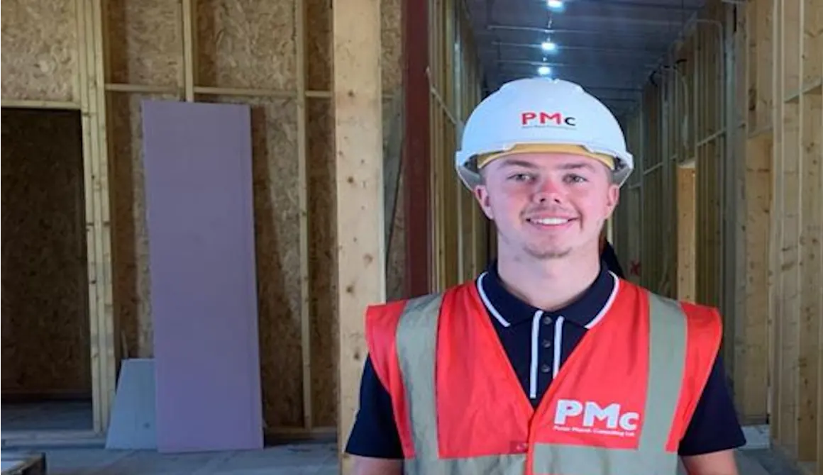 HSDC alumni in high vis and a helmet at a construction site.