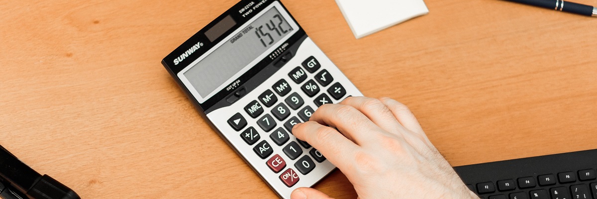 person using a calculator on a desk