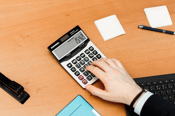 person using a calculator on a desk