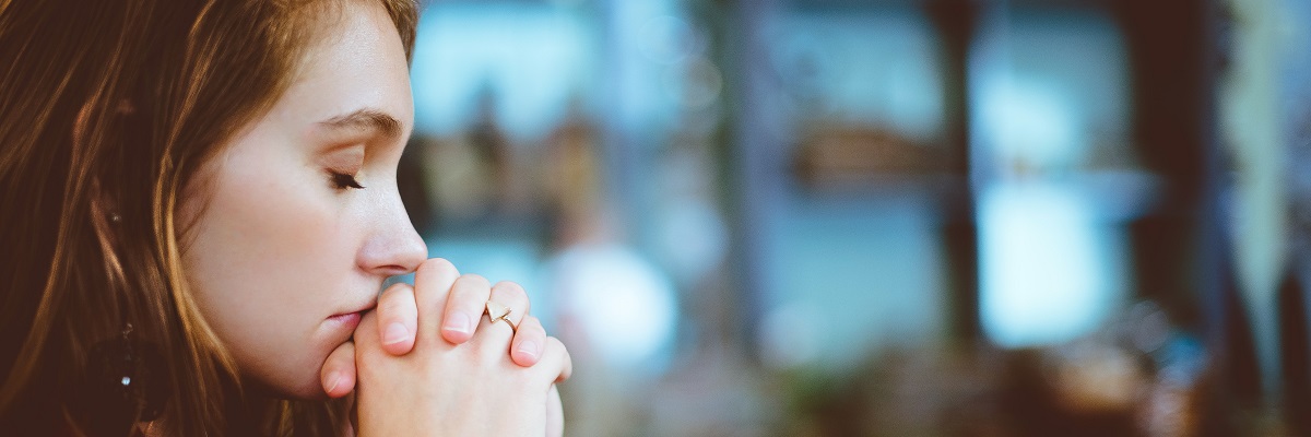 a women with her eyes closed deep in thought