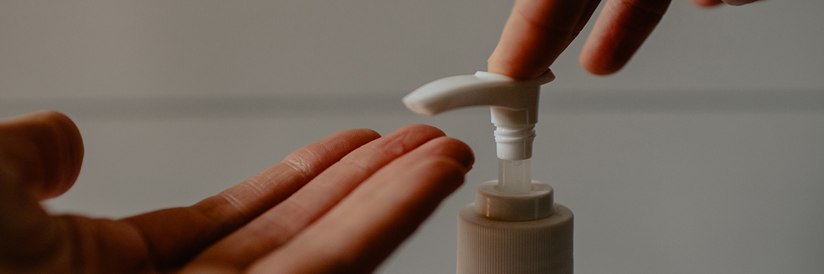 close up of someone pressing on a soap dispenser into hand