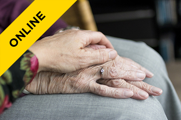 two elderly people holding hands