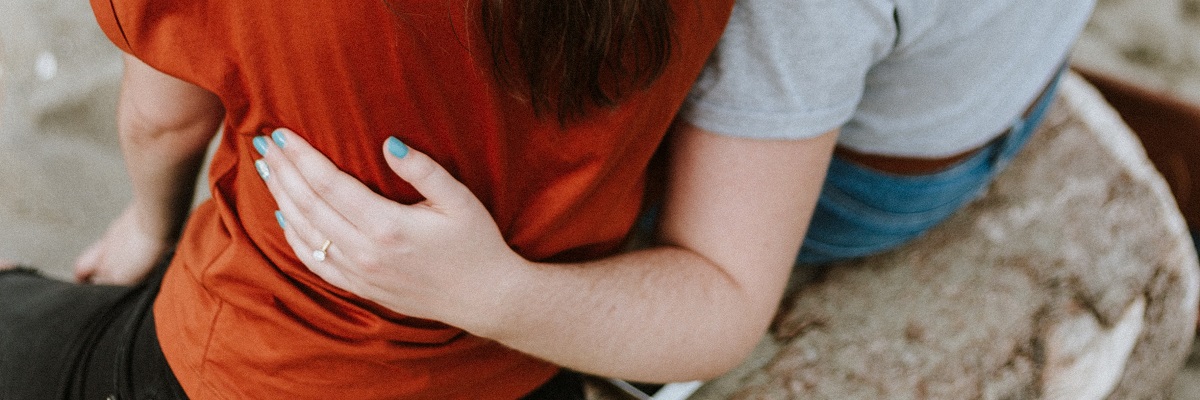 two women supporting each other with their arms around each other