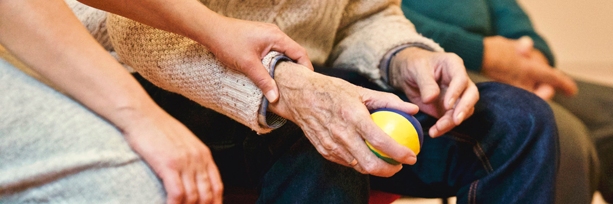 close up of an elderly persons hands and someone holding their hand