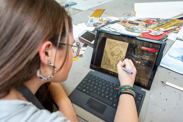 student drawing digitally on a tablet