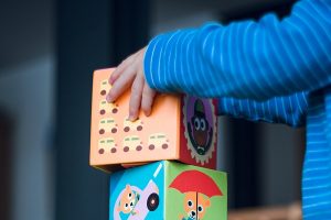 a young child playing with building blocks