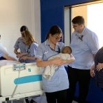 nursing t level students with a baby simulator and their nursing lecturer