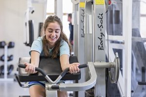 student using equipment at gym at alton campus