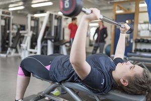 student using equipment at gym at alton campus