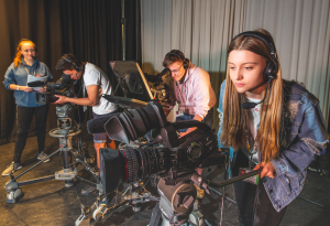 students using media equipment including filming cameras