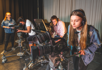 students using media equipment including filming cameras