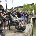 a statue being pulled down by the pubic