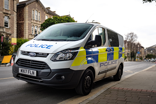 a police van parked on the side of a road