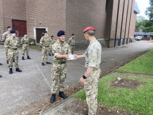 Cadet receiving an award from a senior officer