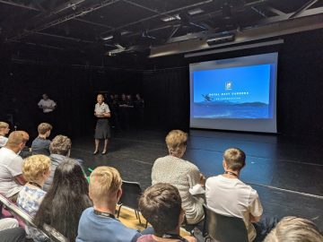 Royal Navy officer talking to students