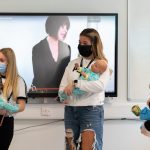 students holding baby simulators