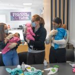 students holding baby simulators