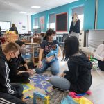 students holding baby simulators