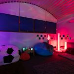 a view of the sensory room with mood lighting and bean bags