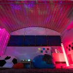 a view of the sensory room with mood lighting and bean bags