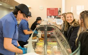 students in the studio cafe at south downs at the till choosing their lunch