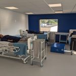 Patient simulators laying on hospital beds