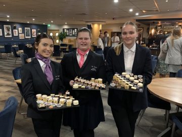 Three students serving canapes