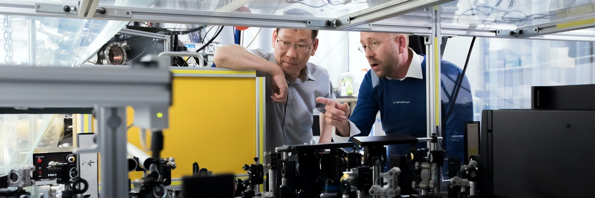 two males looking at machinery